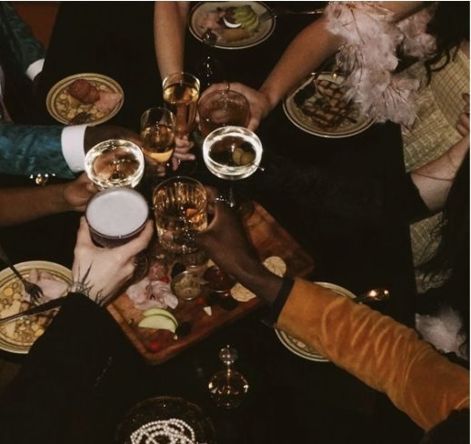 Friends sharing a table of food and drinks